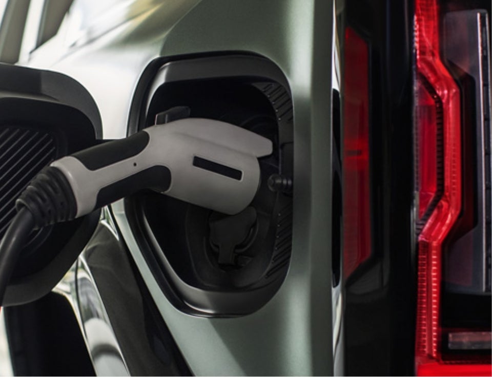 Close up of charging port with charger plugged in on a GMC Hummer EV SUV - Vachon GMC of Mansfield in MANSFIELD MA